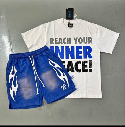White t-shirt with text and blue shorts